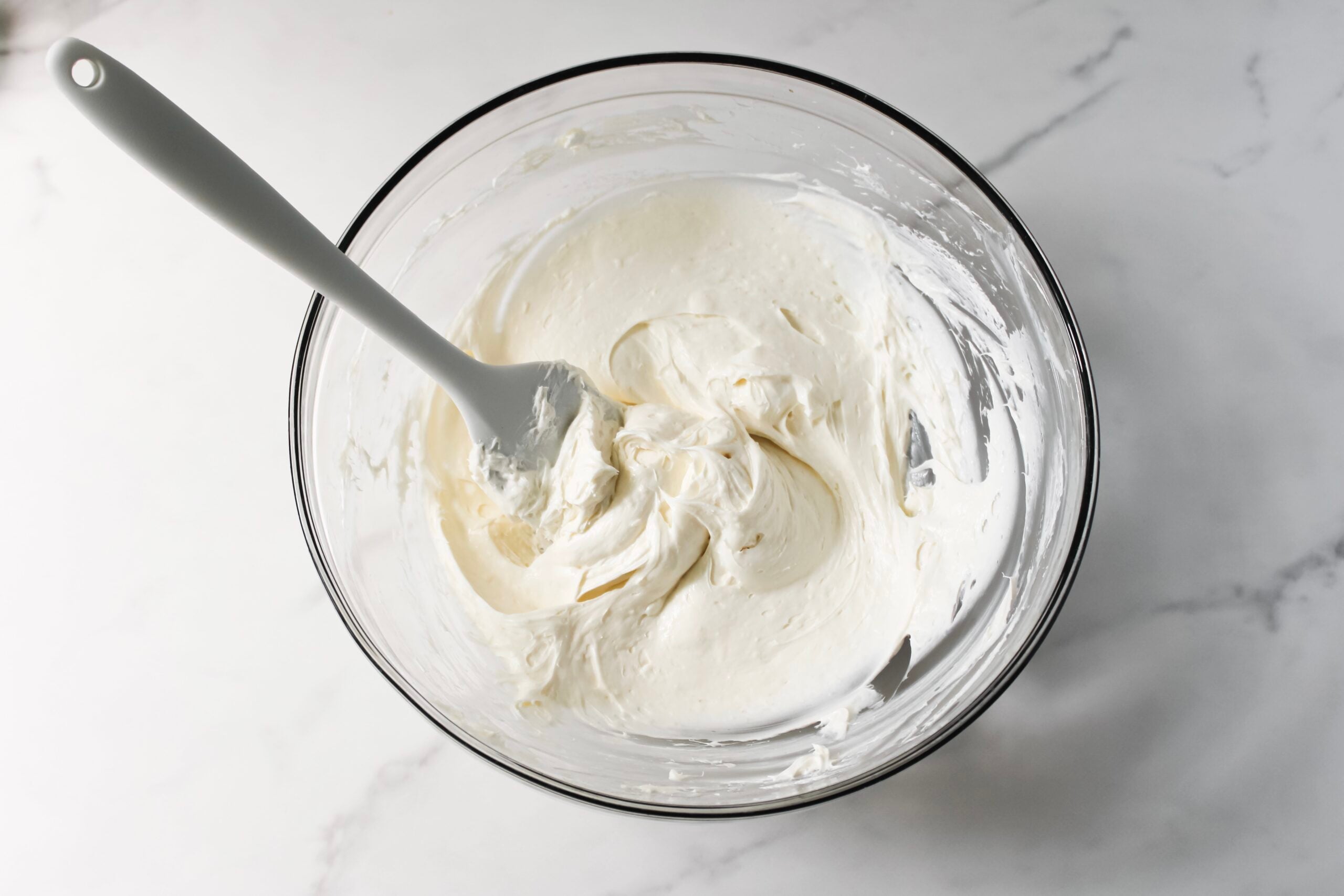 Cream cheese frosting in a bowl.