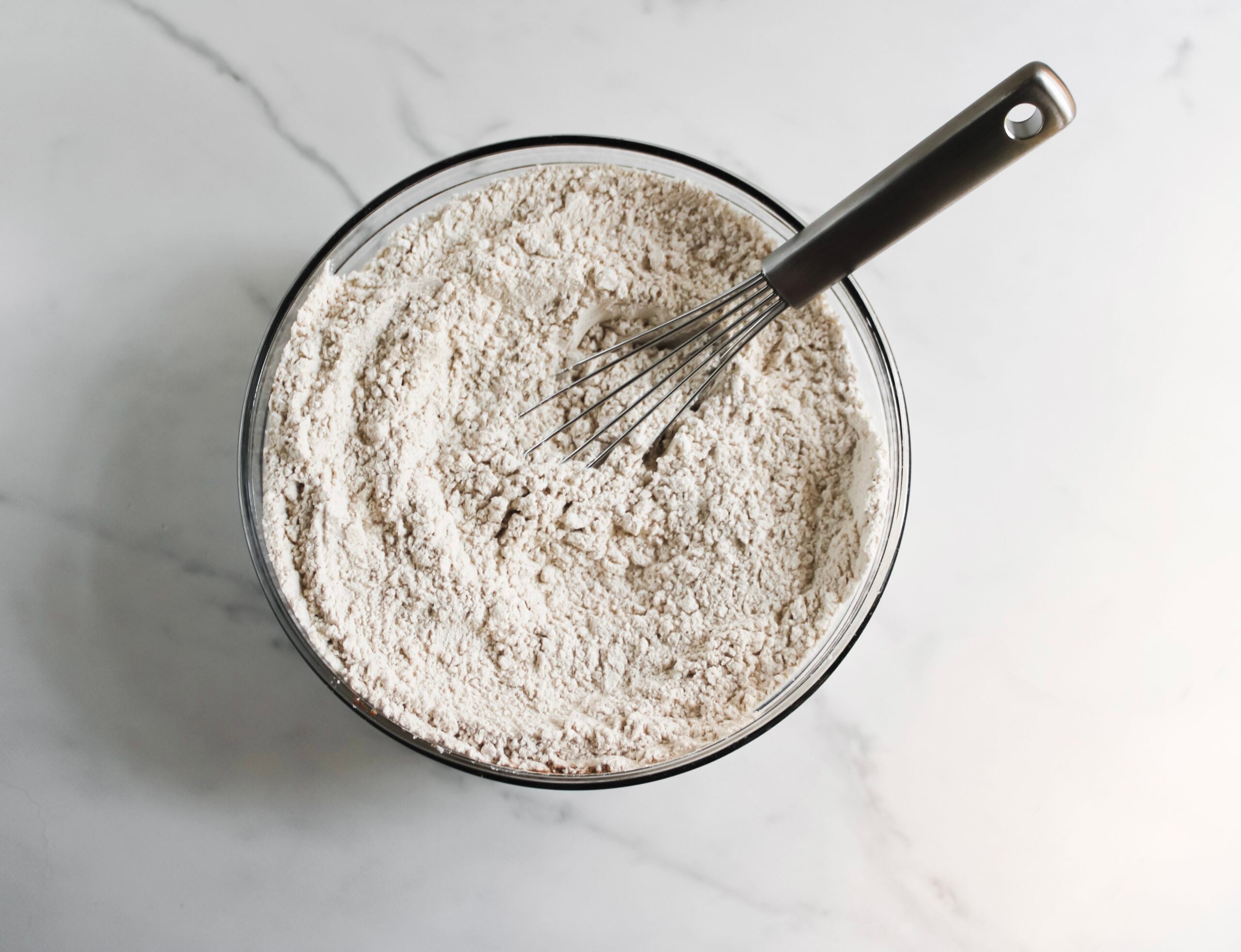 Flour, baking powder, salt, nutmeg, cinnamon in a bowl.