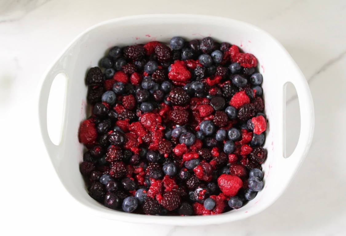 Mixed berries in ceramic dish.