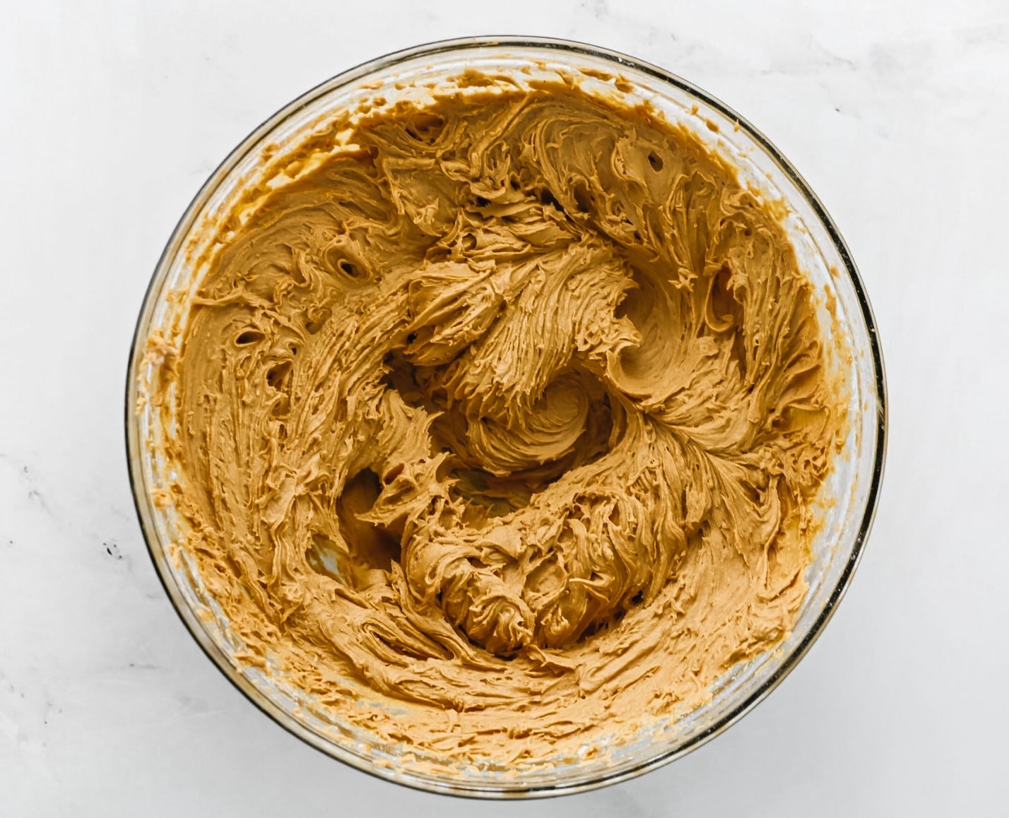 Peanut butter, vanilla, and powdered sugar in bowl.