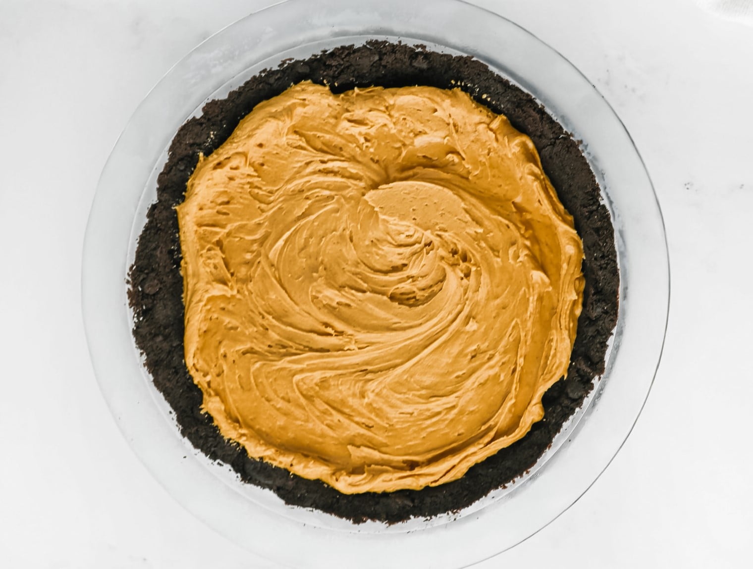 Peanut butter mixture and Oreo crust in pie dish