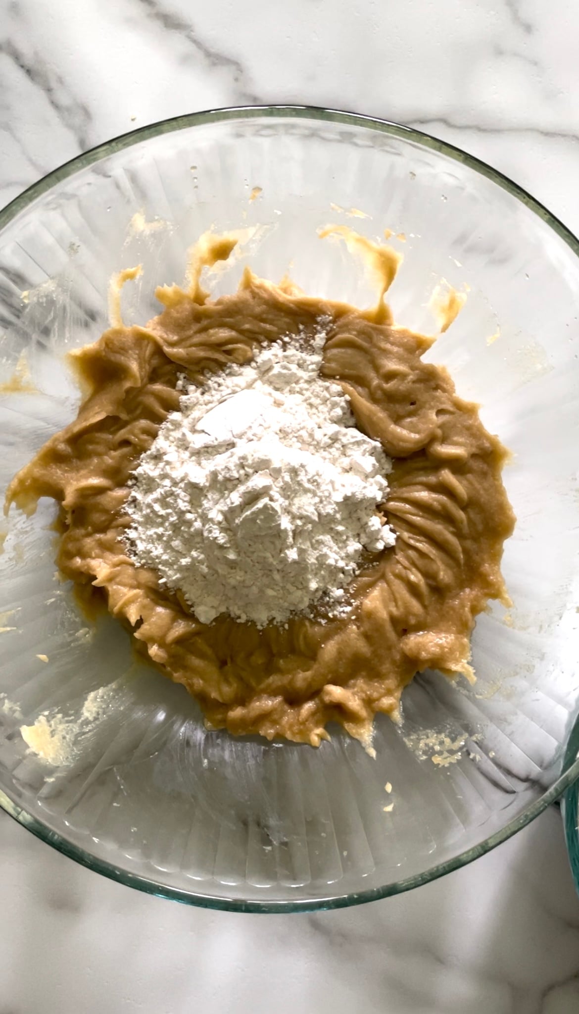 Flour, baking soda, baking powder, and salt in a bowl.