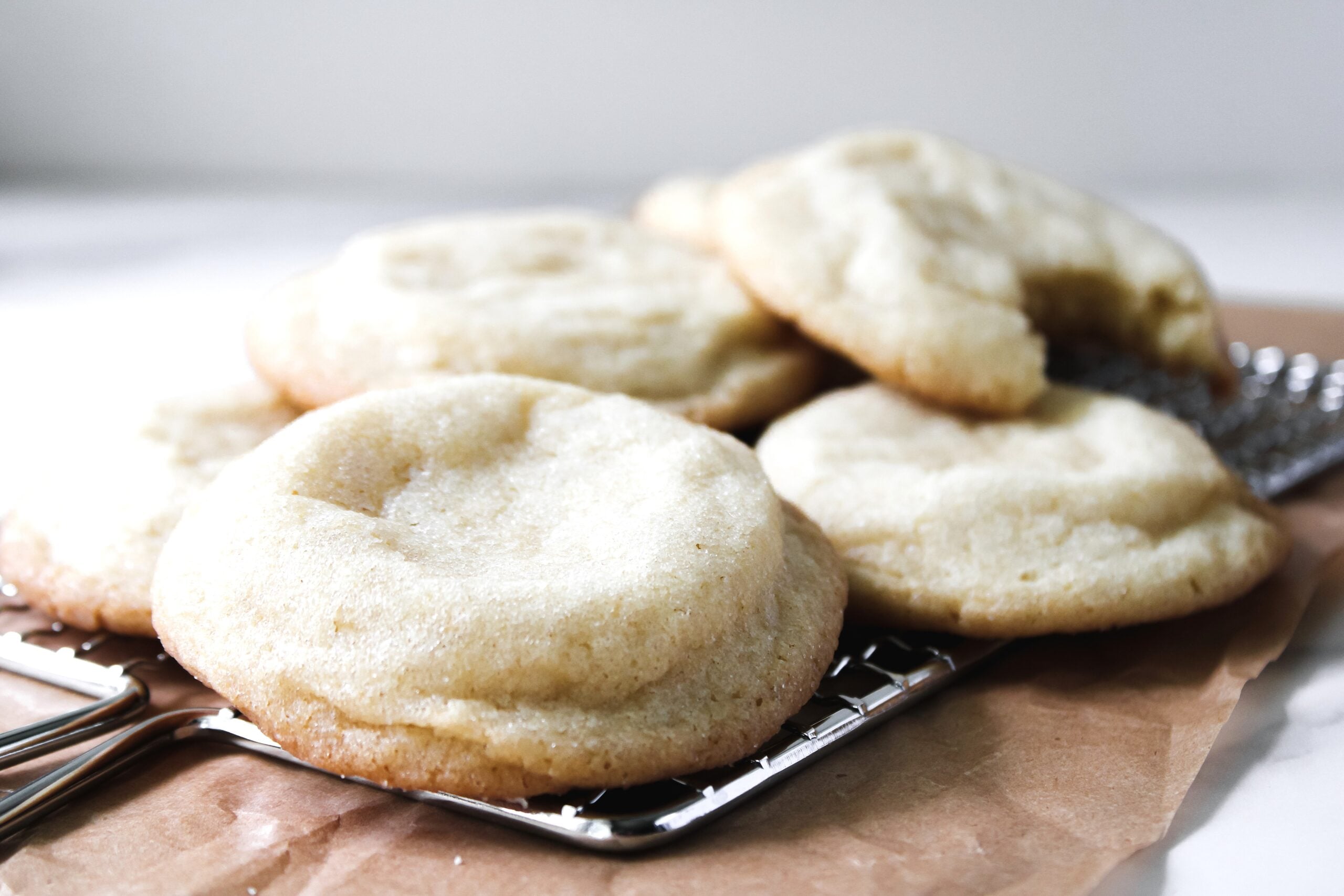Easy Sugar Cookies on a cooling rack with parchment paper.