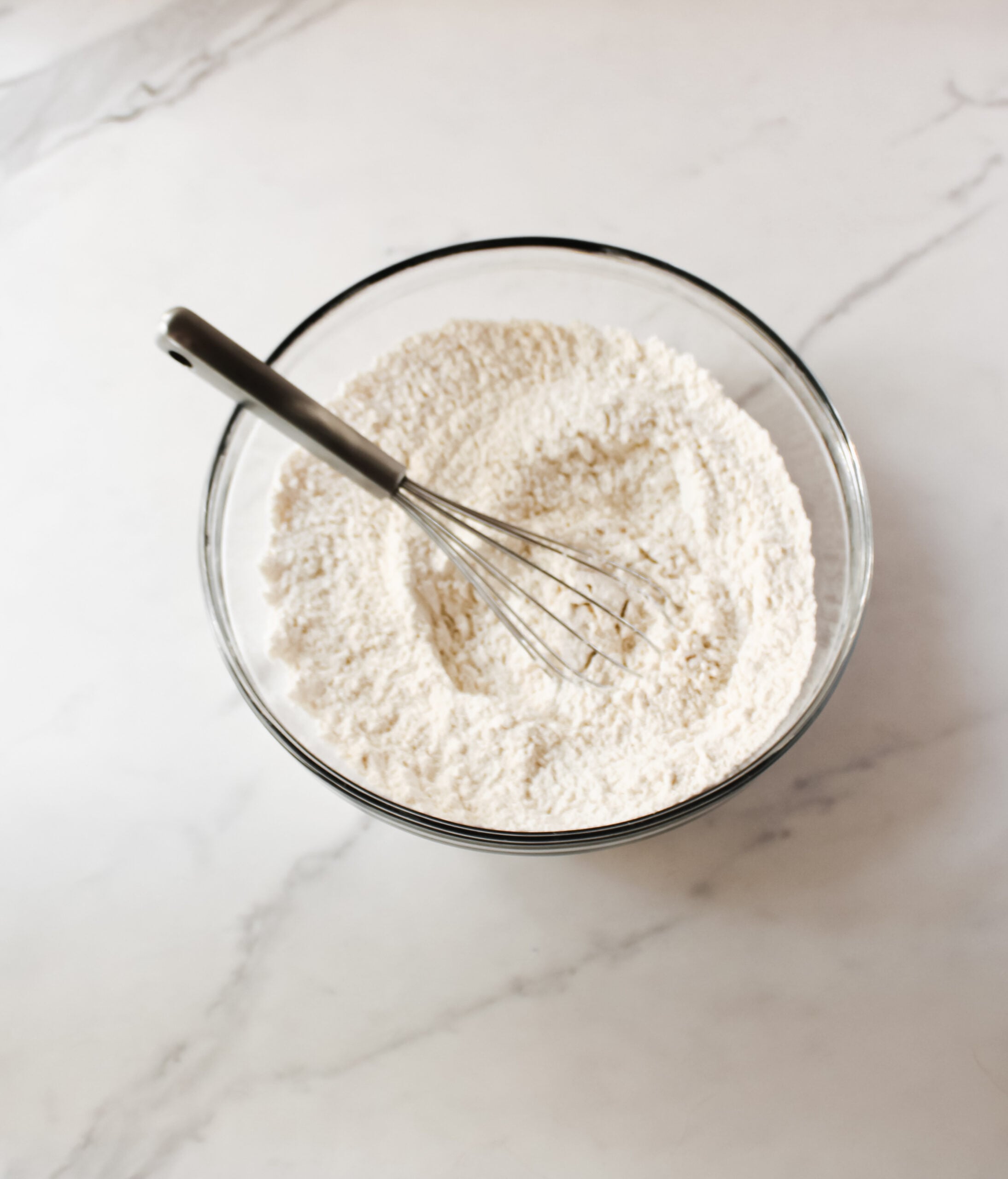 Flour, baking soda, baking powder, and salt in a bowl.