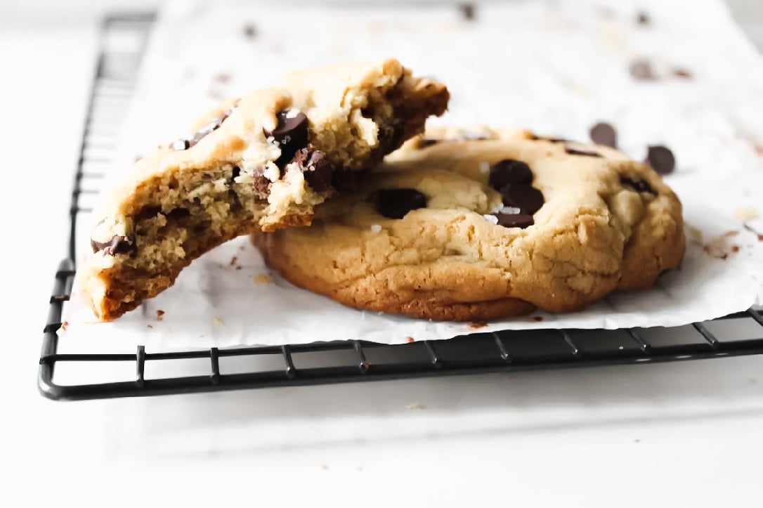 Fully baked chocolate chip cookie on a cooling rack.