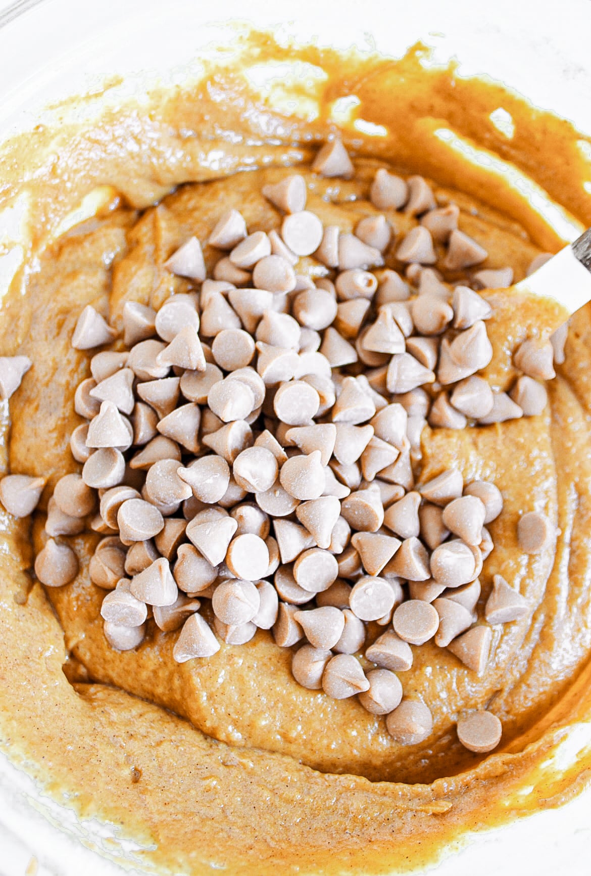 Pumpkin batter with chips in a bowl.