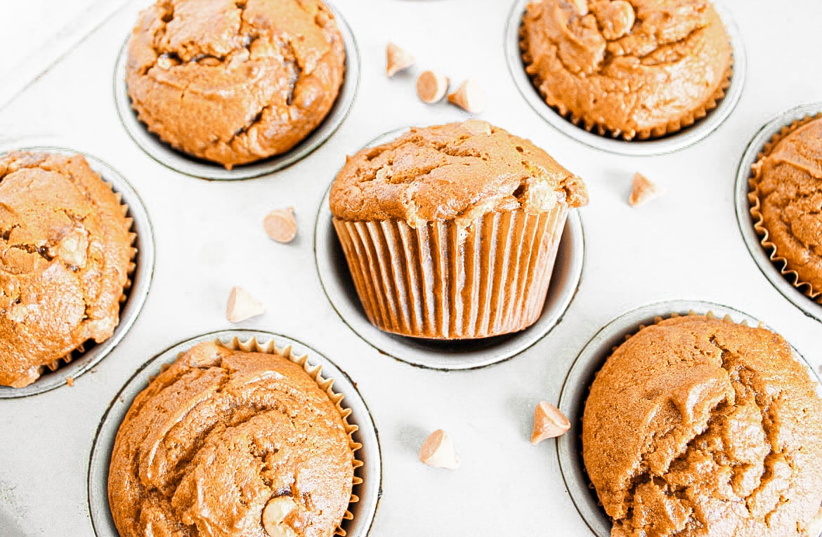 Easy moist pumpkin muffins fully baked in a muffin baking pan.