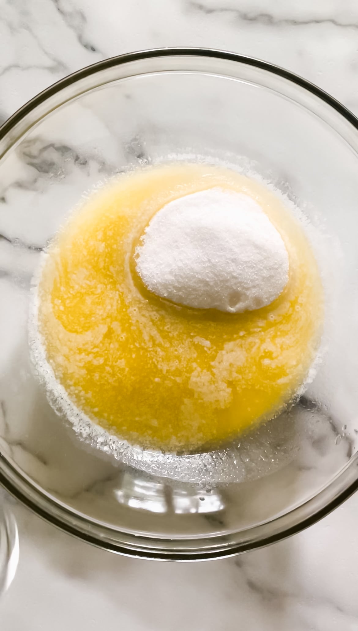 Eggs, sugar, butter, and vanilla in a bowl.