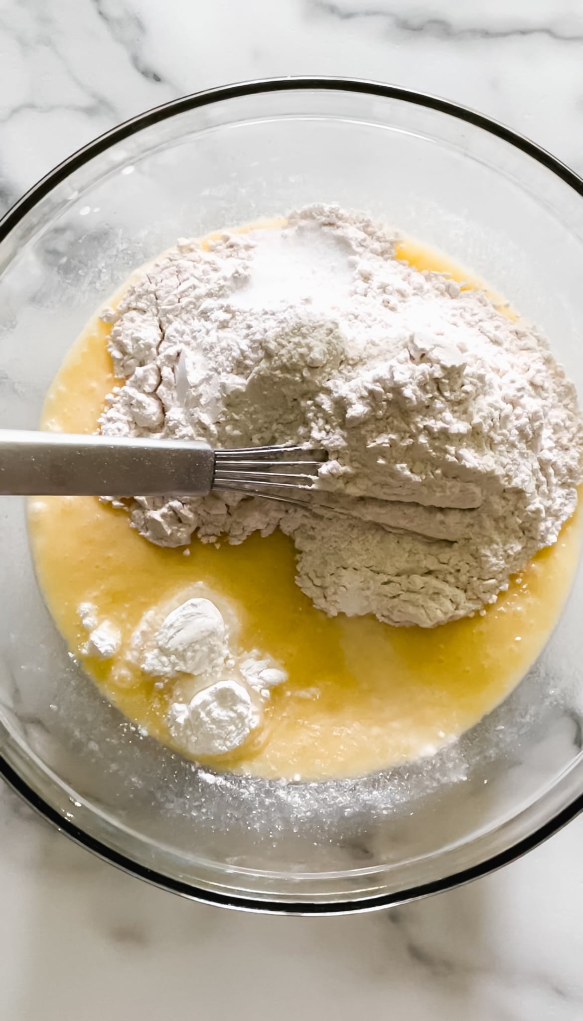 eggs, sugar, butter, flour, baking powder, baking soda in a bowl.