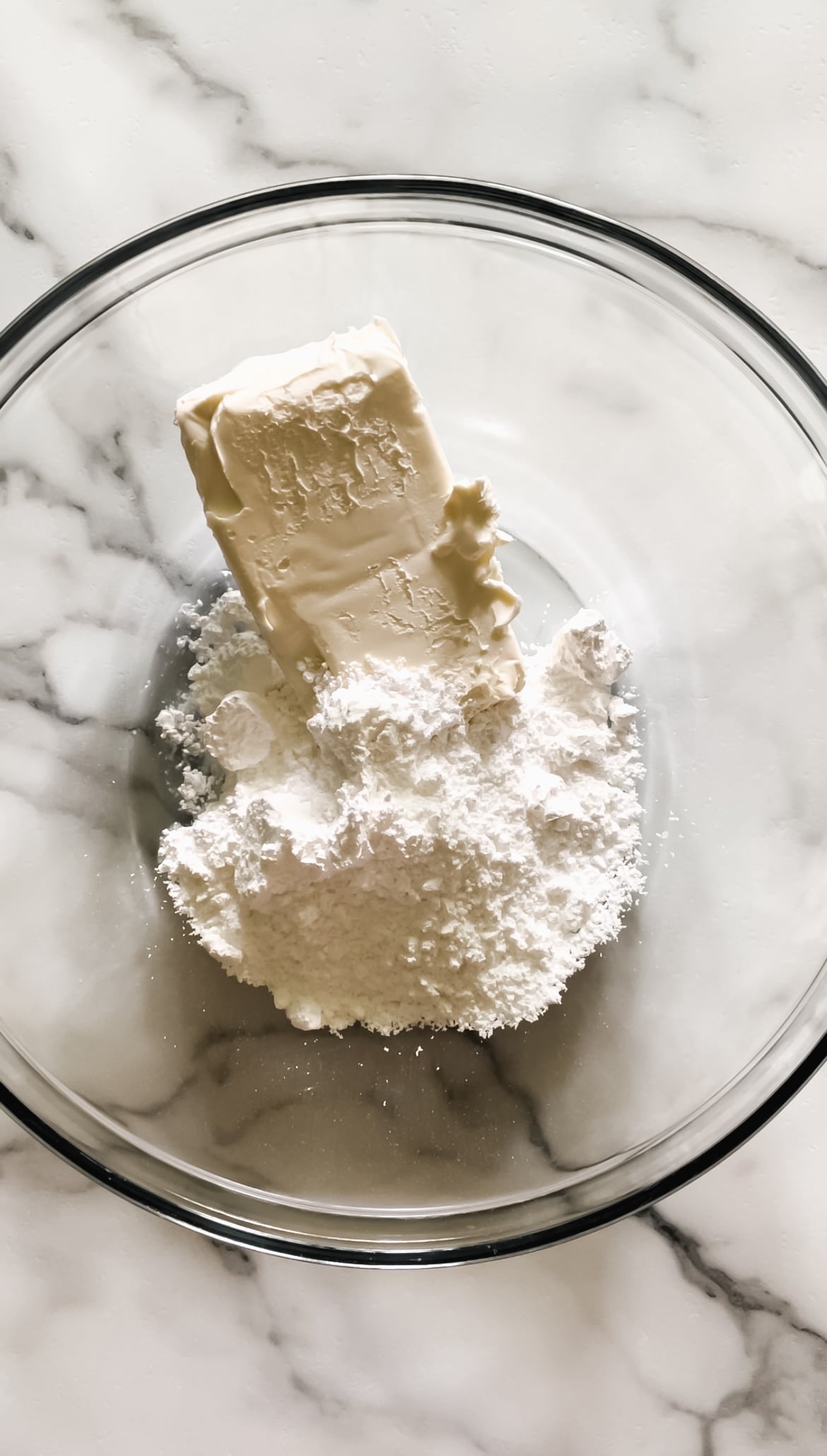Powdered sugar and cream cheese in a bowl.