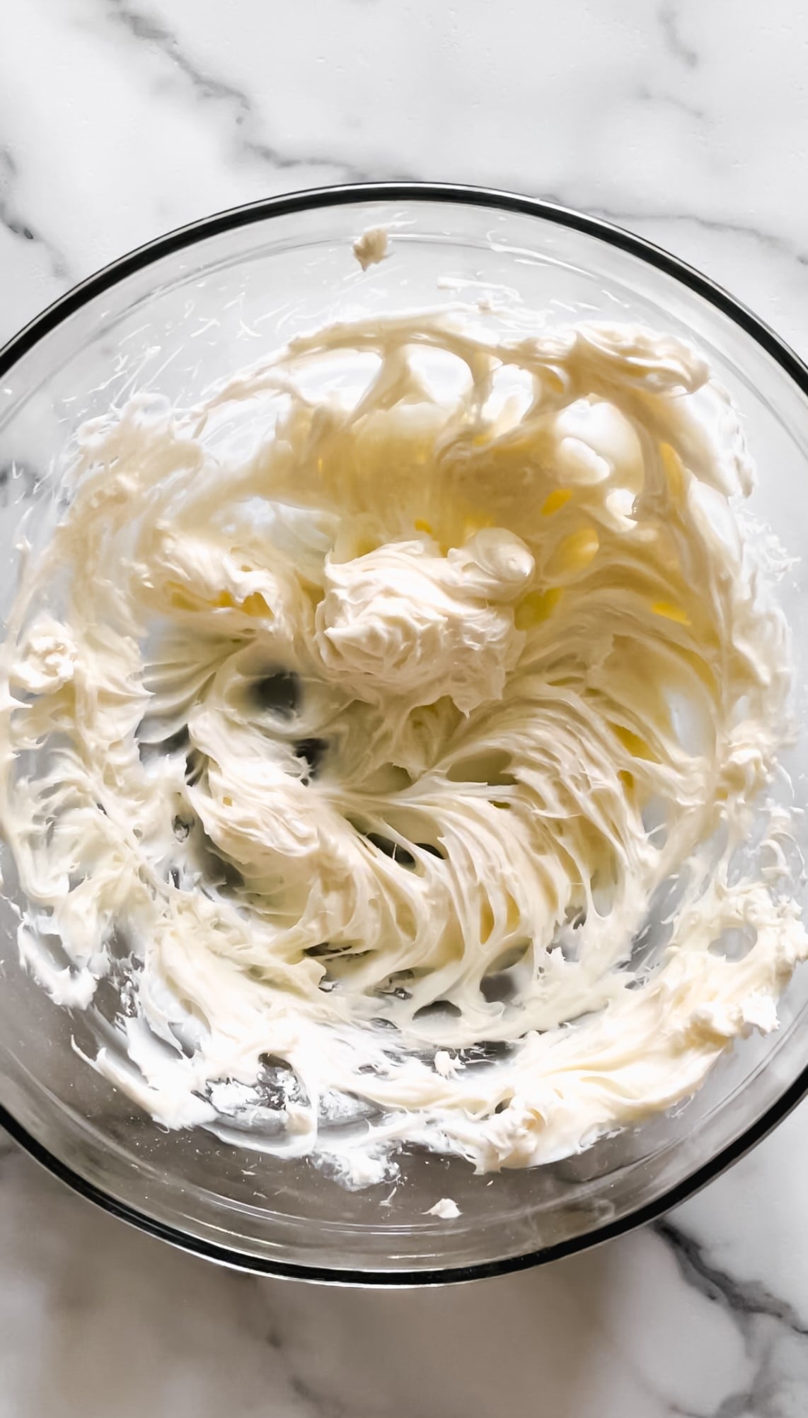 Powdered sugar and cream cheese in a bowl.