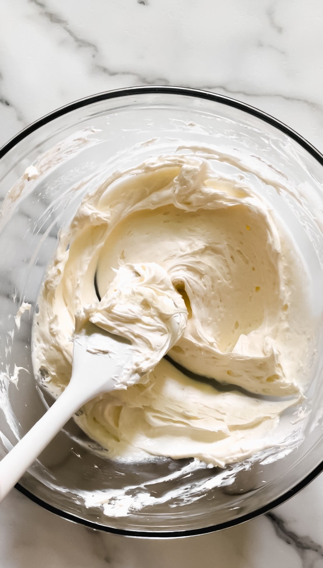 Cheesecake dip in a bowl with a spatula.