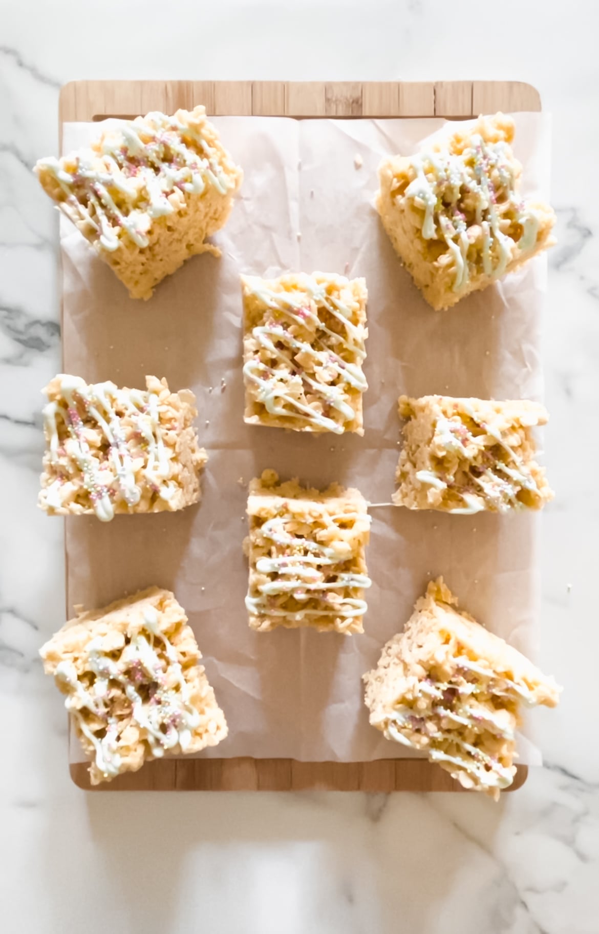 Fully decorated Rice Crispy treats on a cutting board.