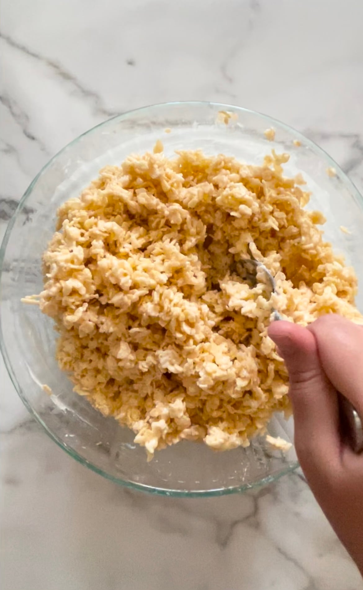 Rice Crispy cereal in a bowl with butter, salt and marshmallows.