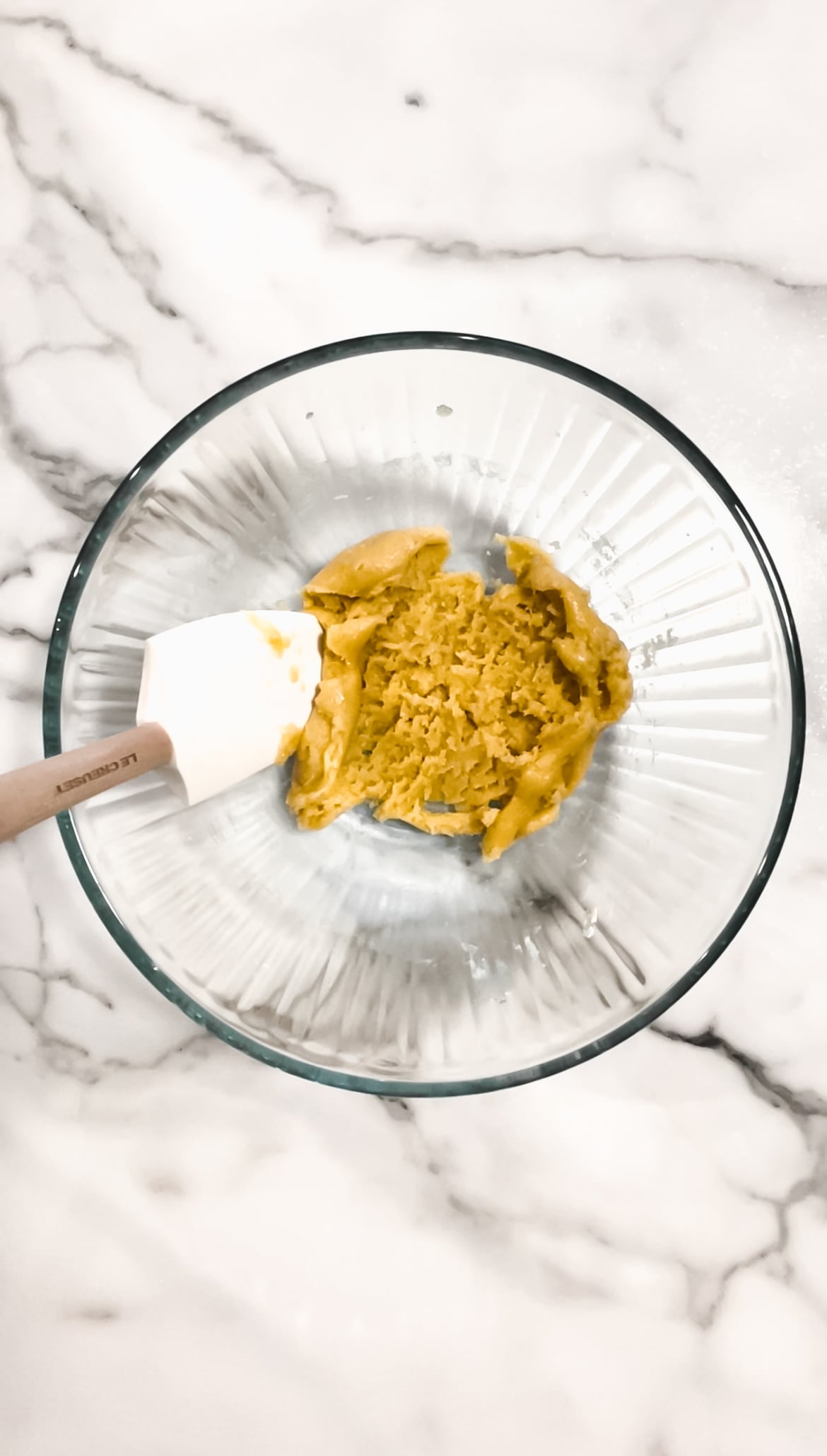 Cookie dough in a bowl with spatula.