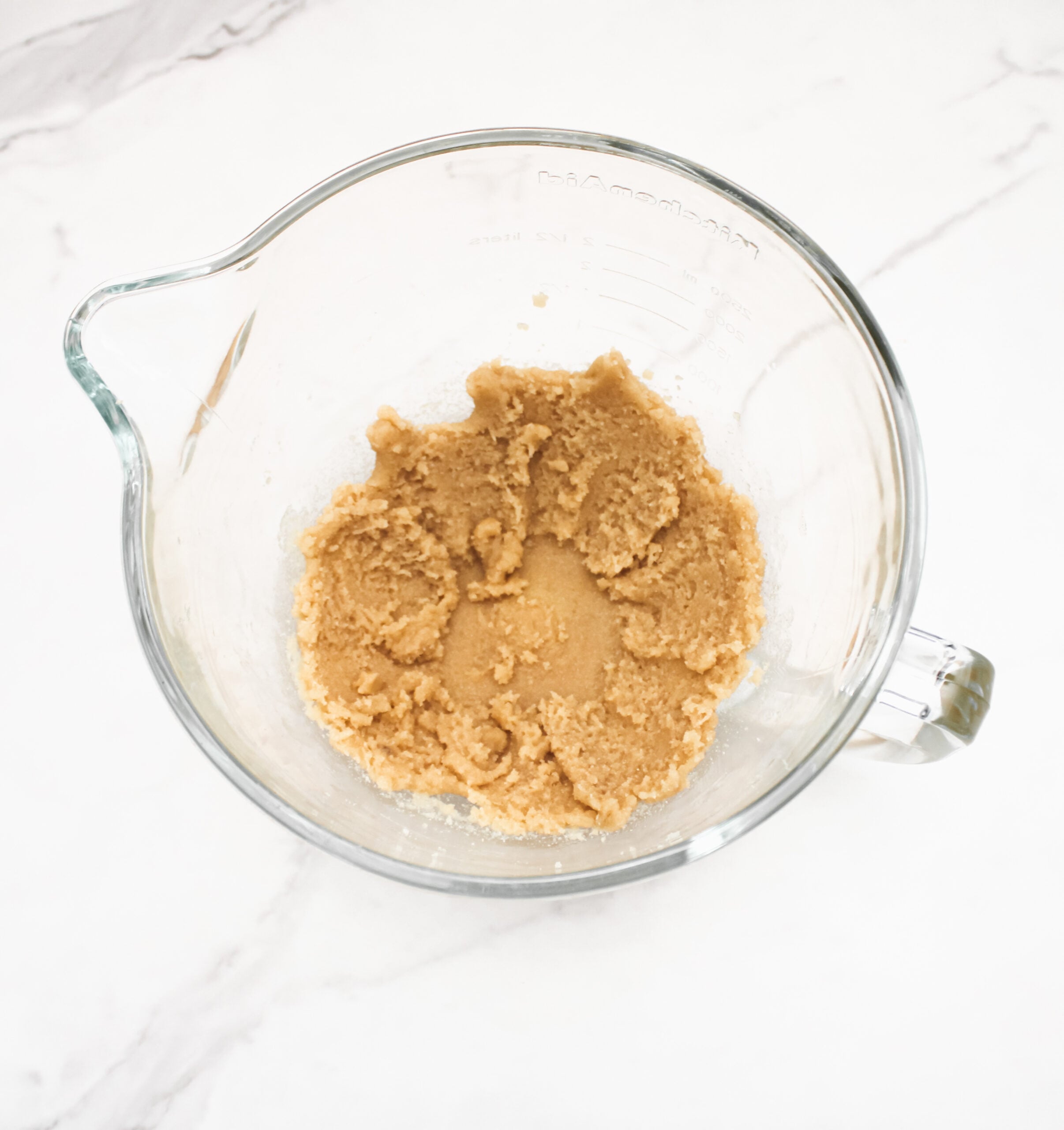Butter, sugar and brown sugar in a mixing bowl.
