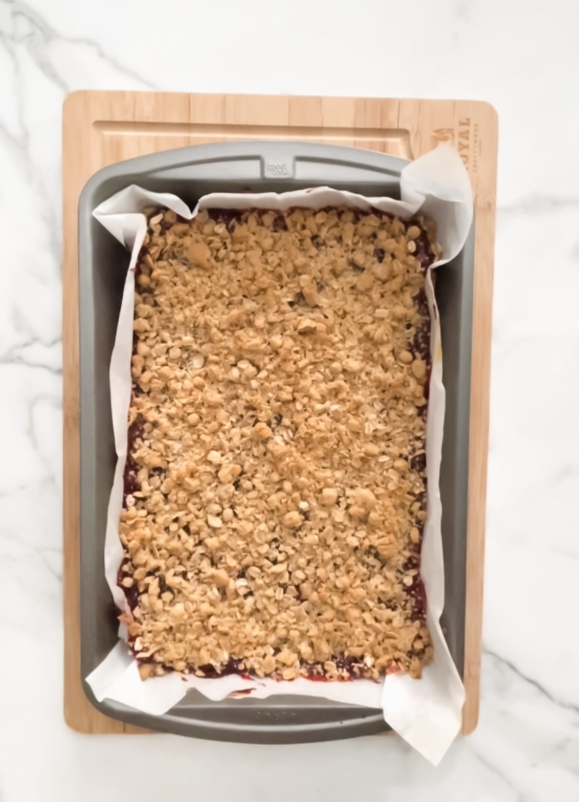 Fully baked raspberry oat bars in a pan.