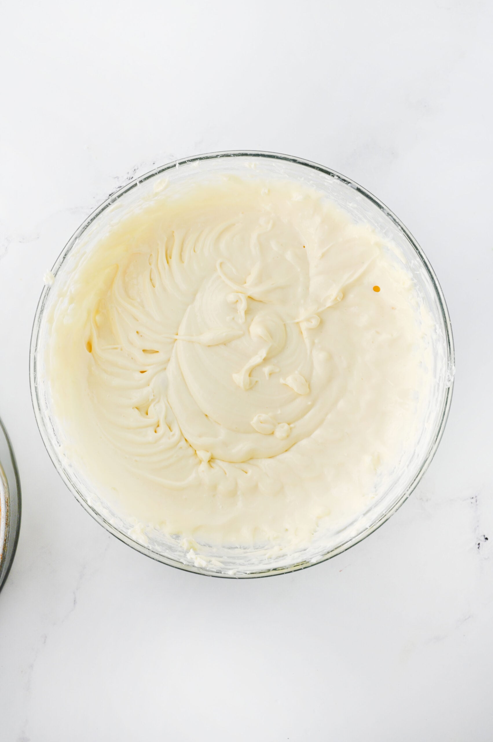 Cream cheese, sweetened condensed milk, vanilla extract, and lemon juice in a bowl.