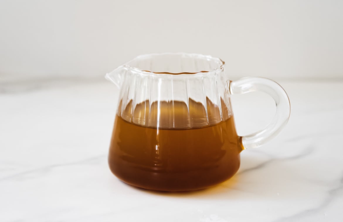 Brown butter in a glass pouring dish.