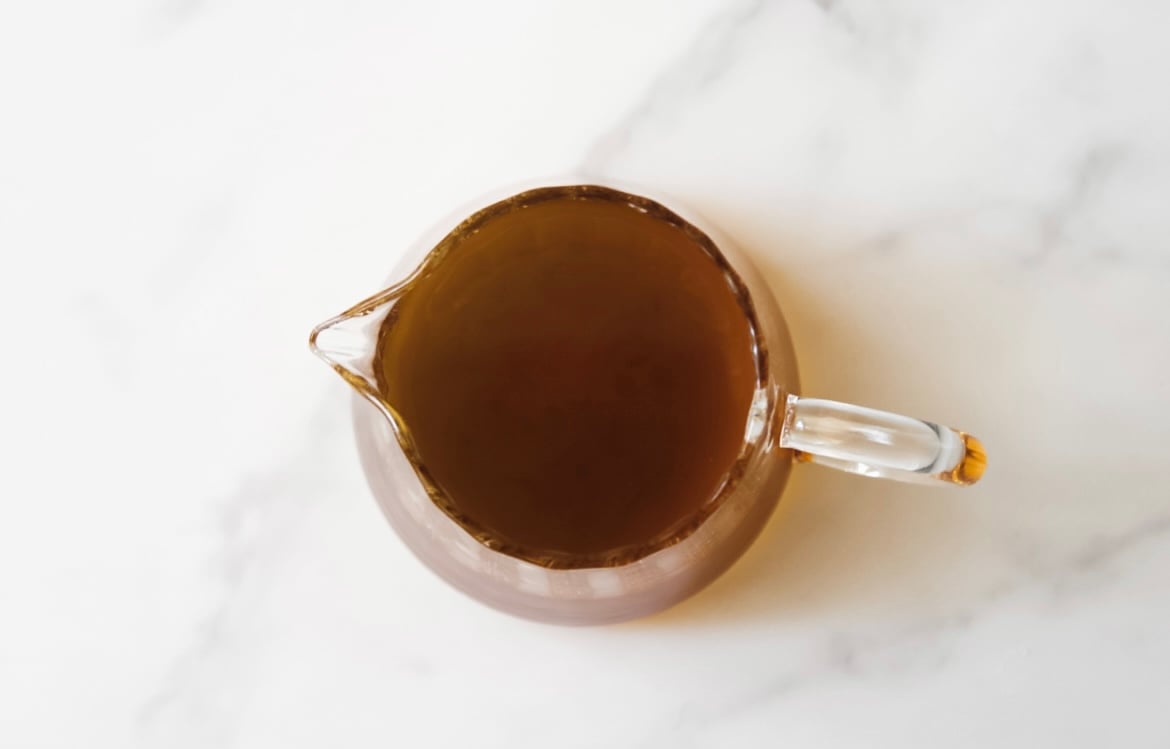 Brown butter in a glass pouring dish.