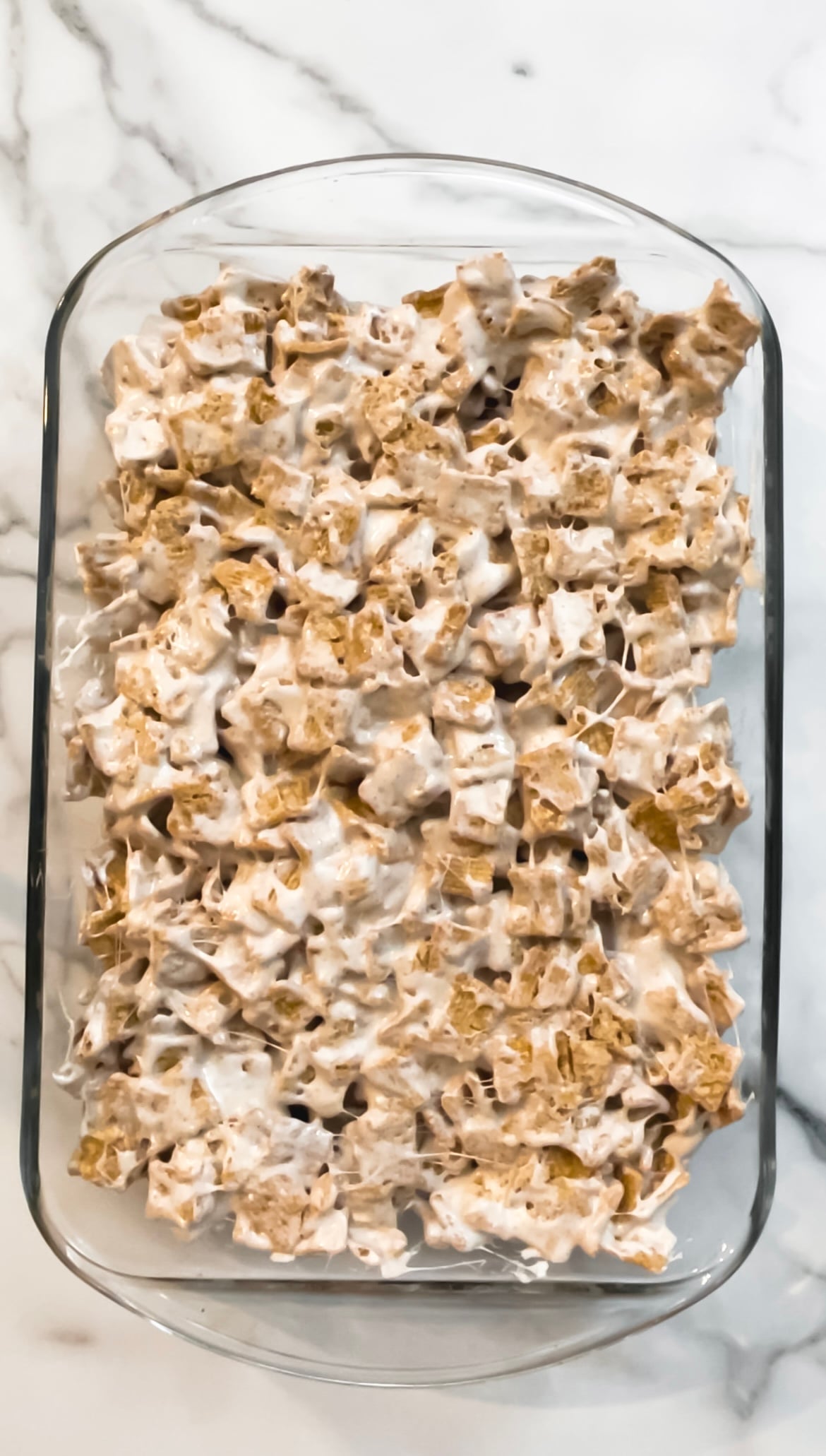 Brown butter cinnamon toast crunch rice krispy treats in a glass baking dish.